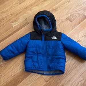 Blue and black north face jacket